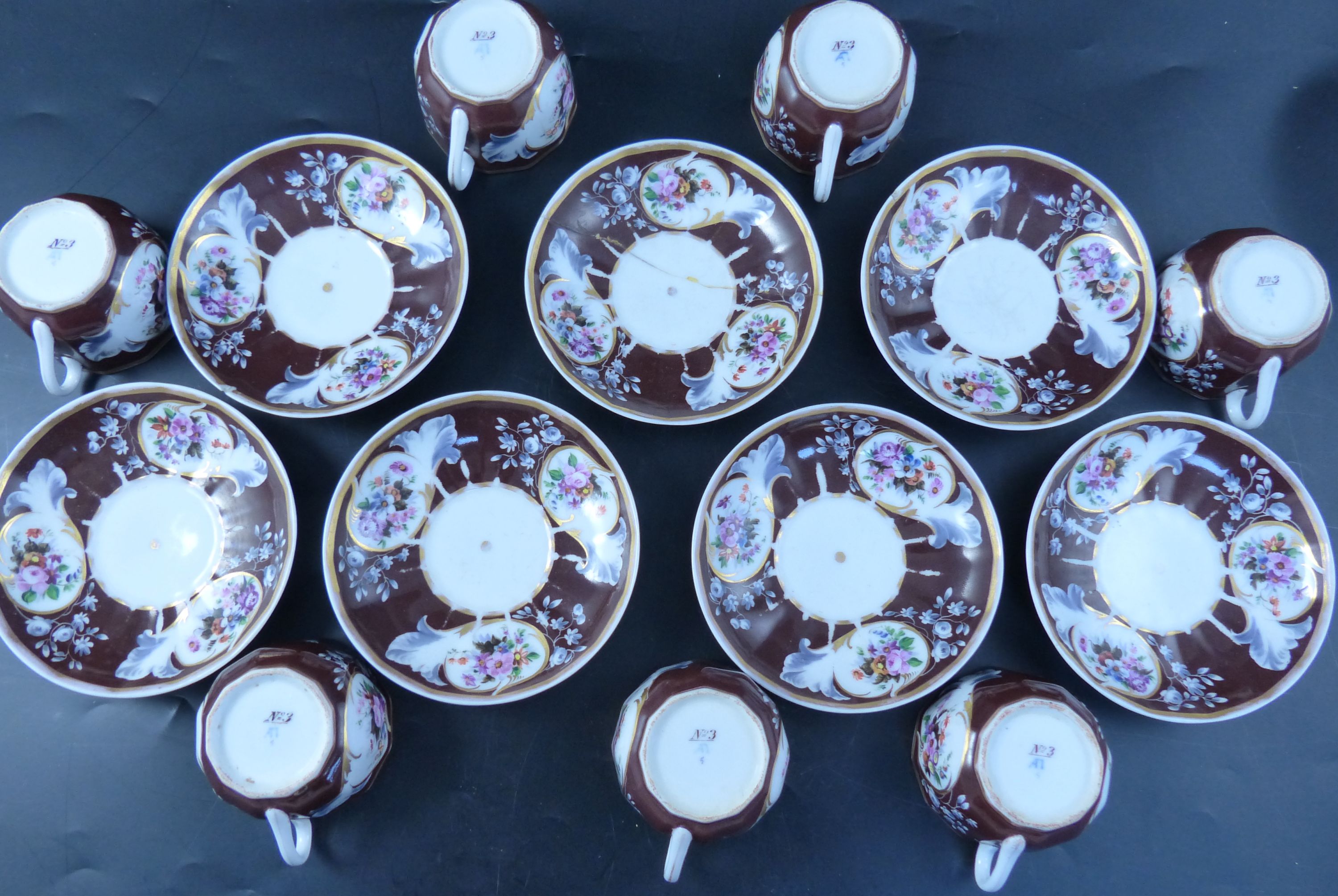 A set of seven Continental porcelain tea cups and saucers